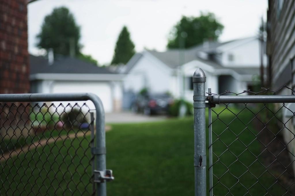 Galvanized chain link fence and gate in a residential yard, shown as a style example of chain link fencing